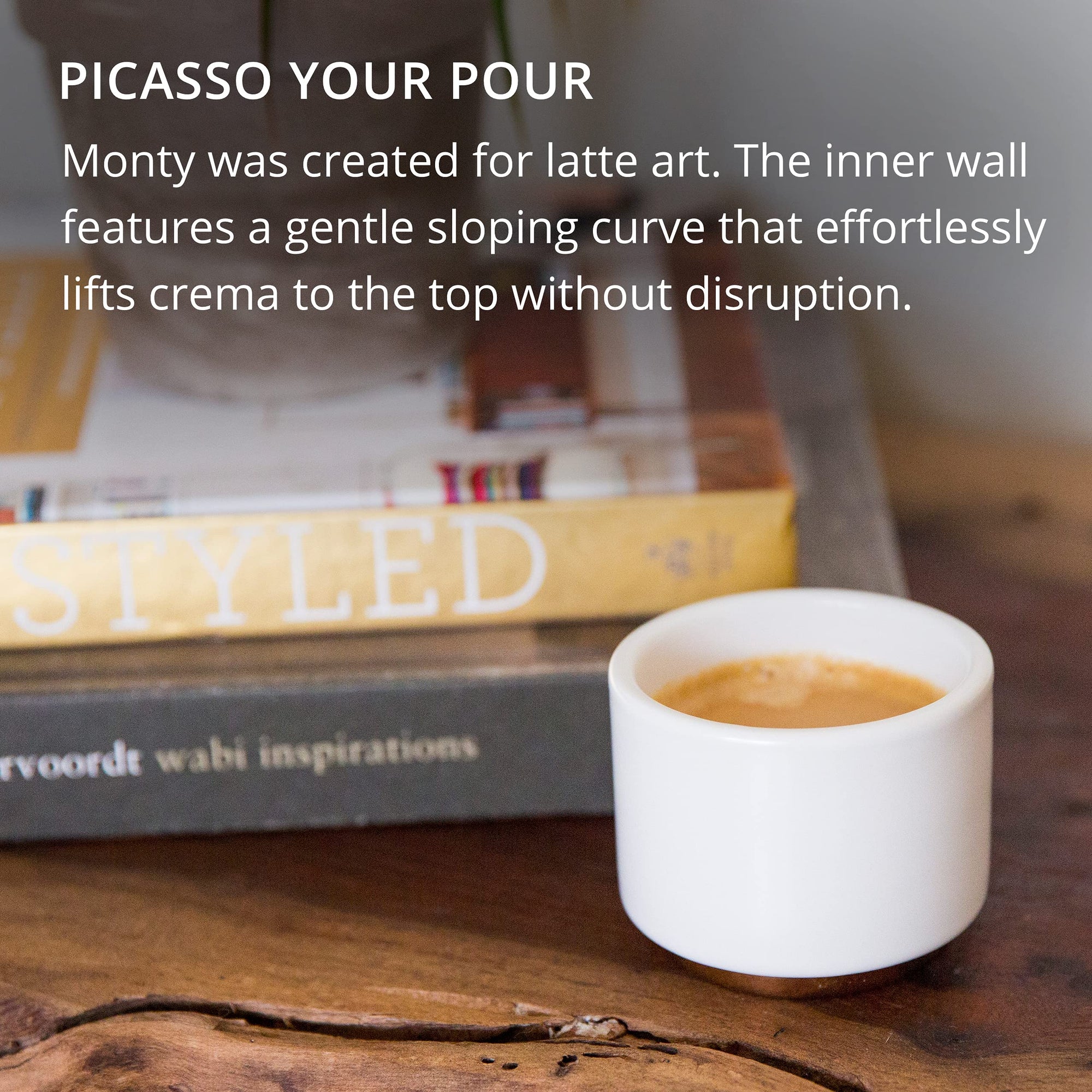 White cup with coffee on a wooden surface with books in the background with text