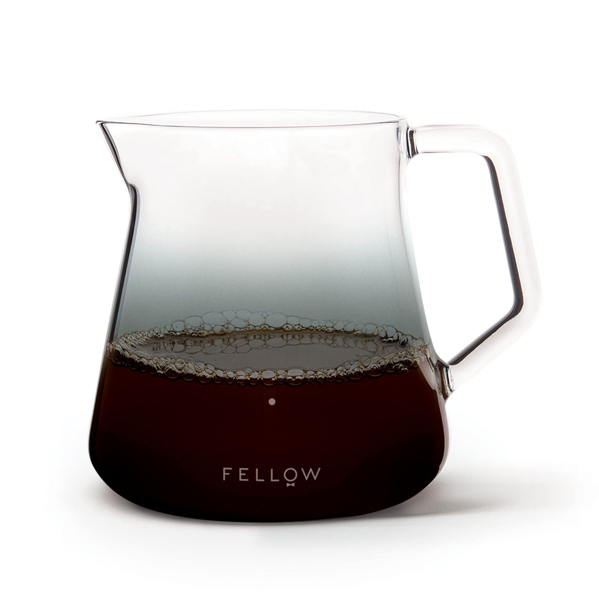 Coffee pitcher with coffee inside on a white background, featuring the Fellow brand.