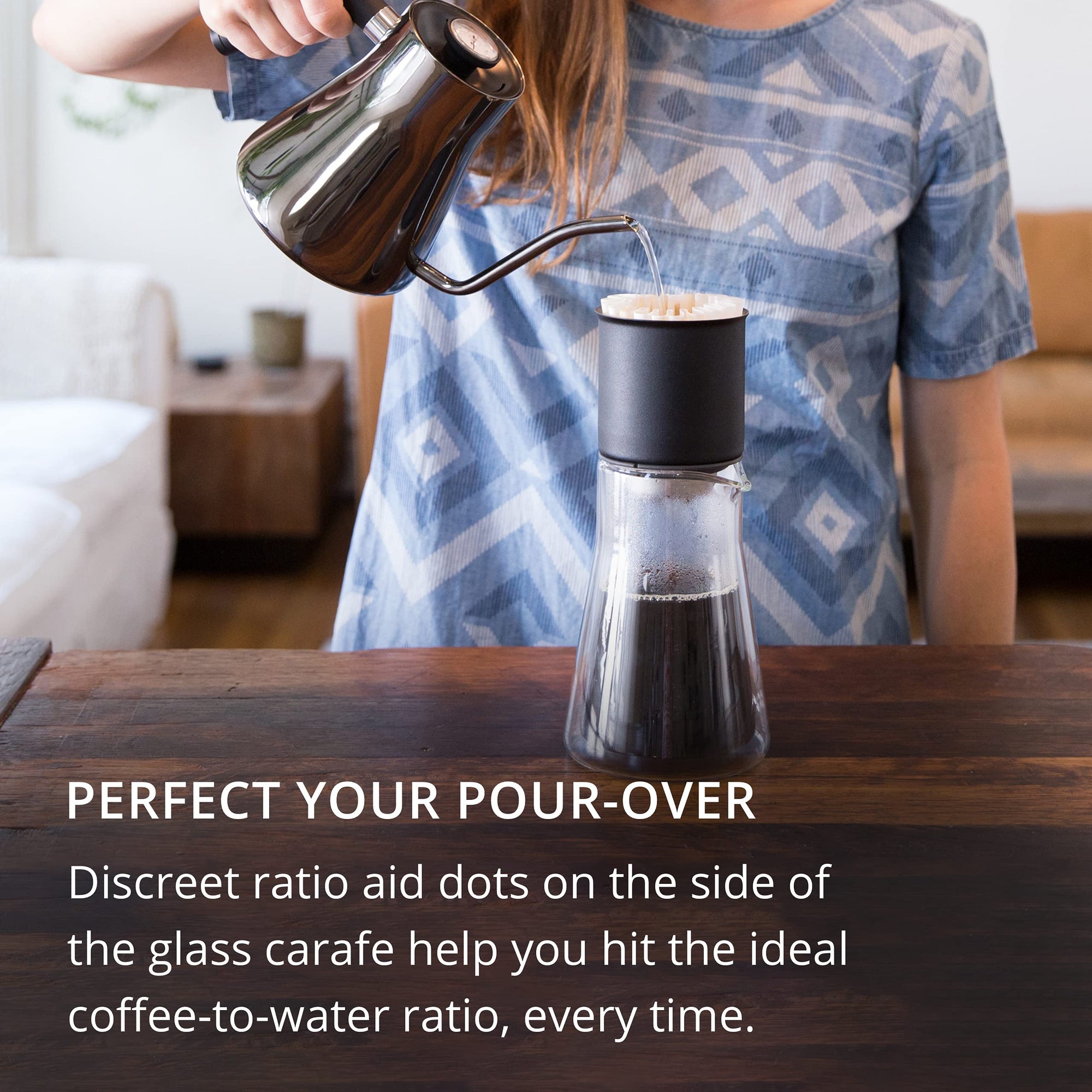 Person pouring liquid into a glass carafe with text about perfect pour-over technique.