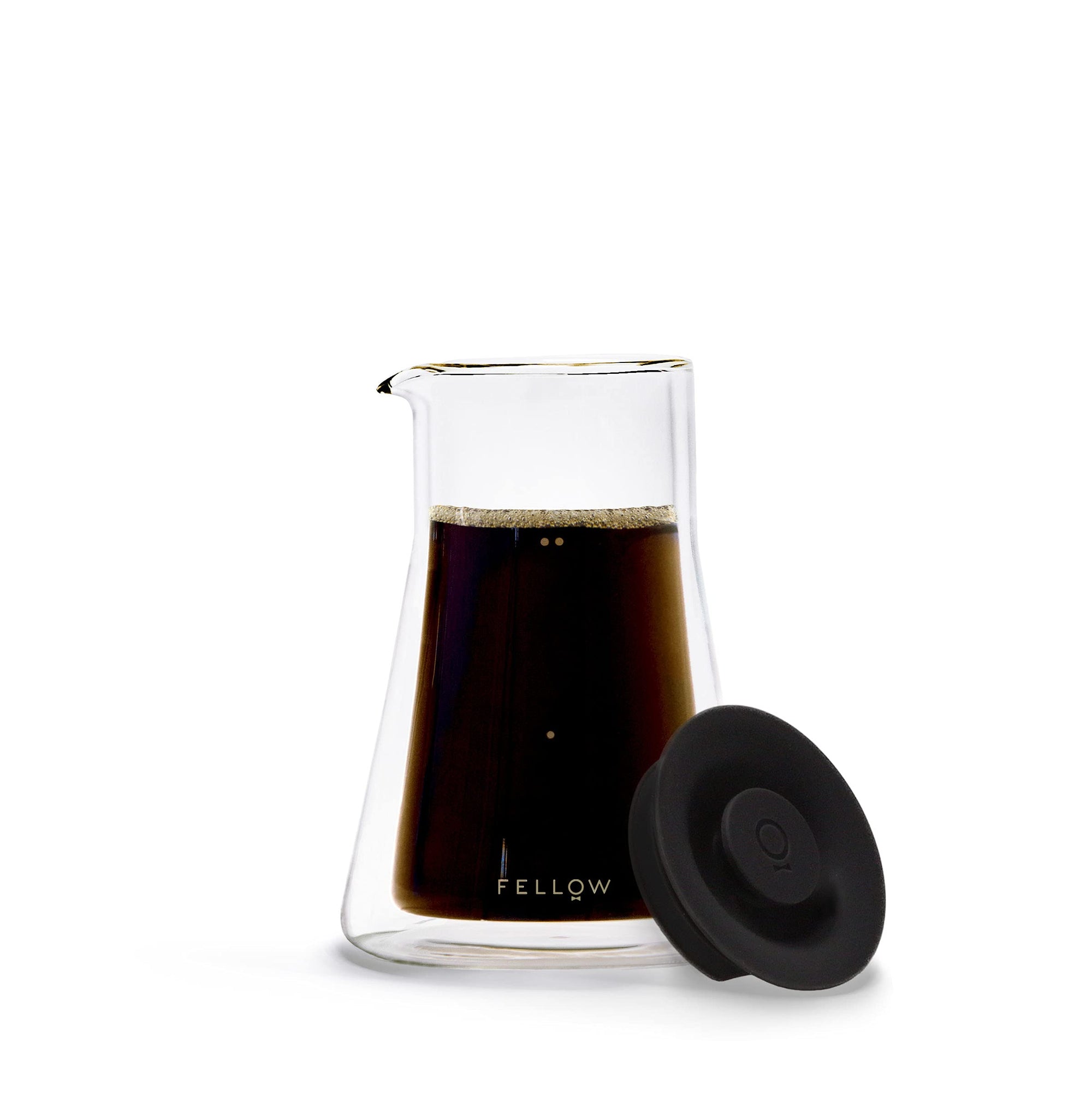 Clear glass carafe with black coffee and black lid on a white background, featuring the 'Fellow' brand.