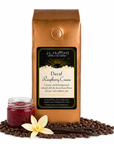 1 lb J.L. Hufford Decaf Raspberry Cream coffee bag with coffee beans, vanilla sticks, and a jar of raspberry jam on a white background