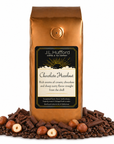 1 lb Chocolate Hazelnut coffee beans bag with chocolate, coffee beans, and hazelnuts on a white background
