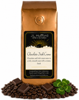 1 lb Chocolate Irish Creme coffee beans bag with coffee beans, blocks of chocolate, and four-leaf clover in front displayed on a white background
