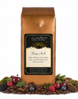 1 lb J.L. Hufford Kenya AA coffee bag with coffee beans, fruits, chocolate, and earth materials on a white background