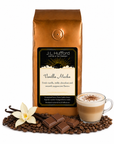 1 lb J.L. Hufford Vanilla Mocha coffee bag with coffee beans, vanilla sticks, milk chocolate, and a glass of a cappuccino on a white background