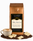 1 lb White Mocha Latte coffee beans bag with coffee beans, white chocolate bars, and a mug of cappuccino in front displayed on a white background