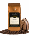 1 lb J.L. Hufford Mudslide coffee bag with coffee beans and mudslide drink on a white background