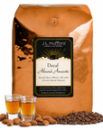 5 lb J.L. Hufford decaf Almond Amaretto coffee bag with two shot glasses of coffee, coffee beans, and almonds on a white background