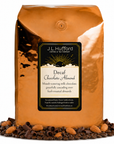 5 lb Coffee bag labeled 'Decaf Chocolate Almond' by J.L. Hufford with coffee beans, chocolate shavings, and almonds on a white background