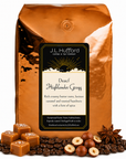 5 lb J.L. Hufford Decaf Highlander Grogg coffee bag with coffee beans, blocks of caramel, hazelnuts, and spice on a white background