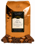 5 lb J.L. Hufford Decaf Milky Way coffee bag with coffee beans, chocolate, and blocks of caramel on a white background