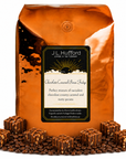 5 lb J.L. Hufford Chocolate Caramel Pecan Fudge Coffee with coffee beans and chocolate pecan fudge blocks drizzled with caramel in front displayed on a white background