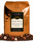 1 lb Chocolate Hazelnut coffee beans bag with chocolate, coffee beans, and hazelnuts on a white background