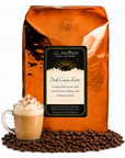 5 lb J.L. Hufford Irish Cream Latte Coffee with coffee beans and glass mug with Irish cream latte in front displayed on a white background
