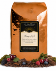 5 lb J.L. Hufford Kenya AA coffee bag with coffee beans, fruits, chocolate, and earth materials on a white background