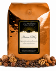 5 lb J.L. Hufford Mexican SHG coffee bag with coffee beans and an assortment of nuts on a white background
