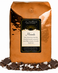 5 lb J.L. Hufford Mounds coffee bag with coffee beans, blocks of chocolate, and flakes of coconut on a white background