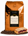 5 lb J.L. Hufford Raspberry Streudelcake coffee bag with coffee beans and a slice of raspberry streudelcake on a white background
