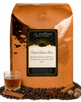 5 lb J.L. Hufford Spiced Butter Rum coffee bag with coffee beans, spices, and glass of rum on a white background