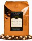 5 lb J.L. Hufford Chocolate Macadamia Coffee beans bag with coffee beans and macadamia in front displayed on a white background