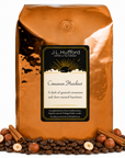 5 lb Cinnamon Hazelnut coffee beans bag with coffee beans, cinnamon sticks, and hazelnuts in front displayed on a white background