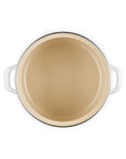 Dark cream inside of the enamel on steel traditional petite stockpot with handles on a white background