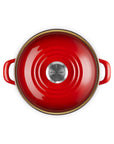 Top view of the cerise 3.8 qt enamel on steel traditional petite stockpot with lid and handles on a white background