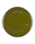 Top view of olive Le Creuset enameled cast iron signature trivet on a white background