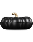 Licorice cast iron pumpkin braiser with handles and gold knob on a white background