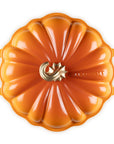 Persimmon cast iron signature pumpkin braiser with handles and a gold knob on a white background