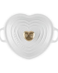 Top view of white heart shaped 1.25 qt cocotte with handles and a light gold heart knob displayed on a white background