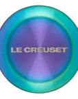 Le Creuset logo on a steel iridescent knob on a white background