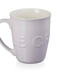 White ceramic mug with 'Cafe' embossed on a white background