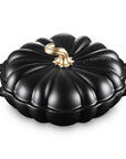 Licorice cast iron pumpkin braiser with handles and a gold knob on a white background