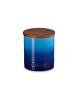 Blue canister with a wooden lid on a white background