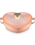 Peche heart shaped 1.25 qt cocotte with handles and a light gold heart knob displayed on a white background