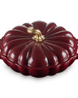Rhone cast iron pumpkin braiser with handles and a gold knob on a white background