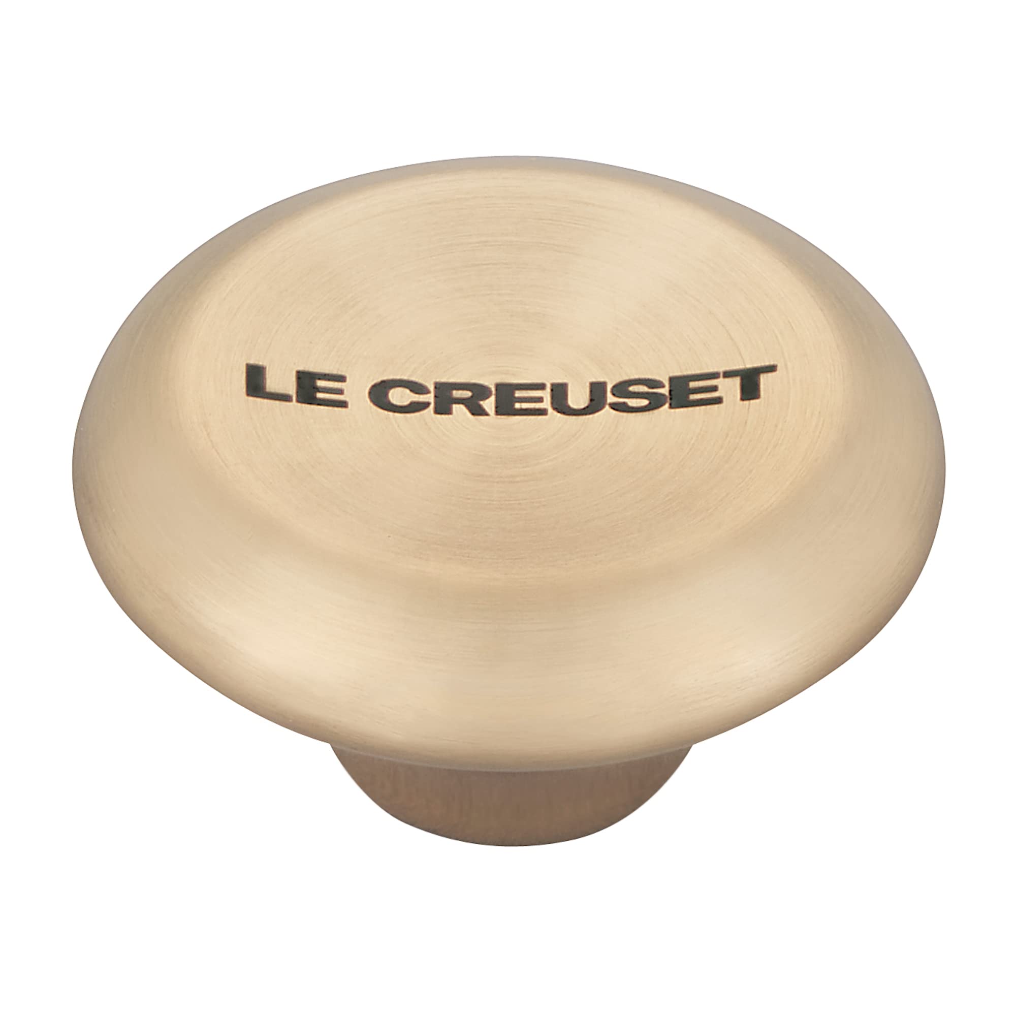 Light gold knob with 'Le Creuset' branding on a white background