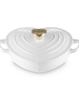 White heart shaped 1.25 qt cocotte with handles and a light gold heart knob displayed on a white background