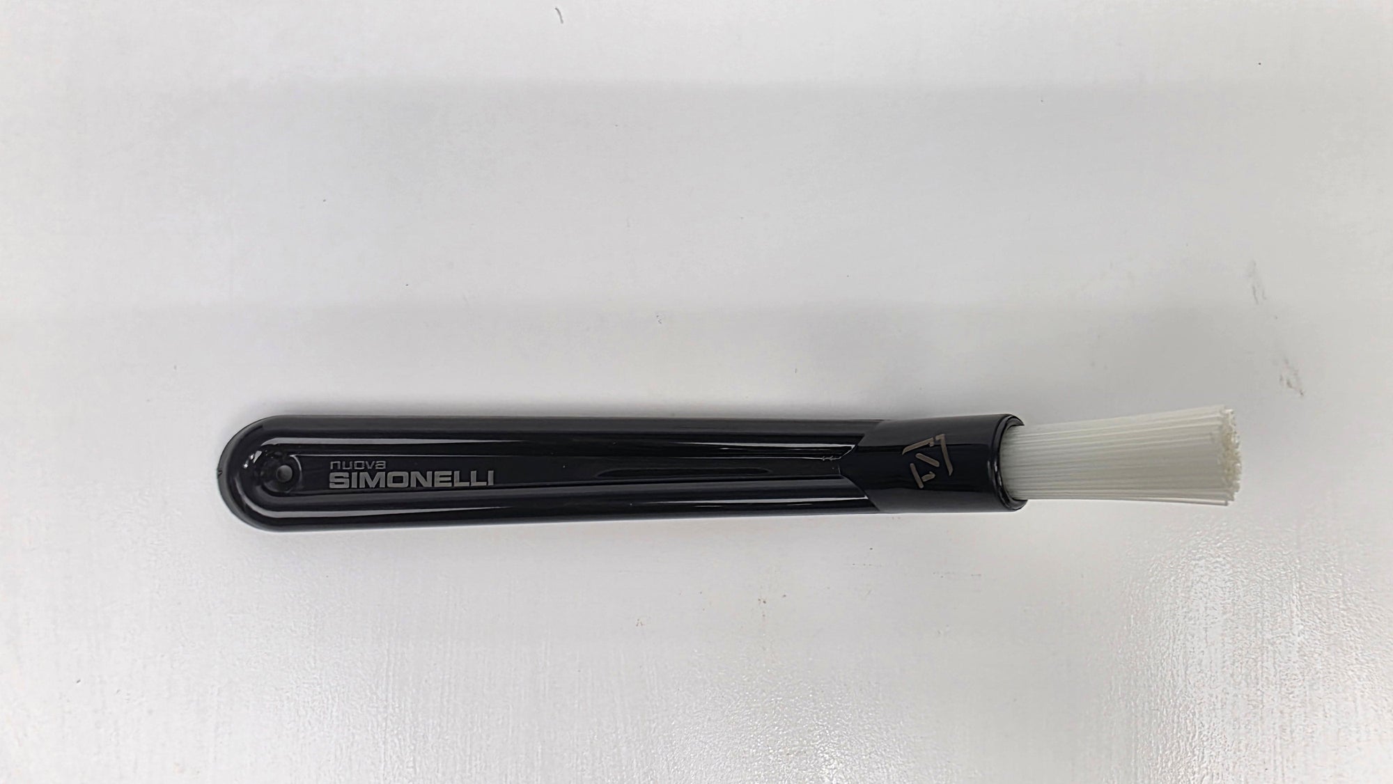 Black brush with white bristle head on a white background