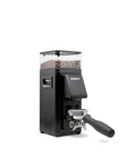Rancilio Stile SD coffee grinder, 'like new' demo unit, with minor blemishes, in black color, with a clear bean hopper on top and a portafilter attached to the front.