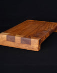 Rico & Plato wasabi teak serving platter displayed on a black surface