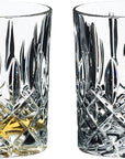 Two Riedel Fine Crystal Tumblers spey whisky with a geometric pattern, one with a small amount of amber-colored liquid, likely whisky, and the other empty