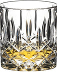 Riedel tumbler spey old fashioned with a brown liquid in the glass on a white background