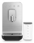 Black, silver Smeg fully automatic coffee machine with a container on the side on a white background