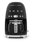 Front view of matte black Smeg coffee machine on a white background