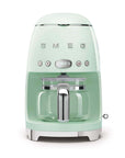 Front view of pastel green Smeg coffee machine on a white background