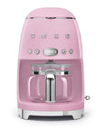 Front view of pink Smeg coffee machine on a white background