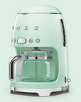 Pastel green Smeg coffee machine on a light green background