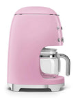 Side view of pink Smeg coffee machine on a white background
